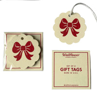 Set of gift tags with red bow design, packaging, and Wallflower Paper & Party branding.