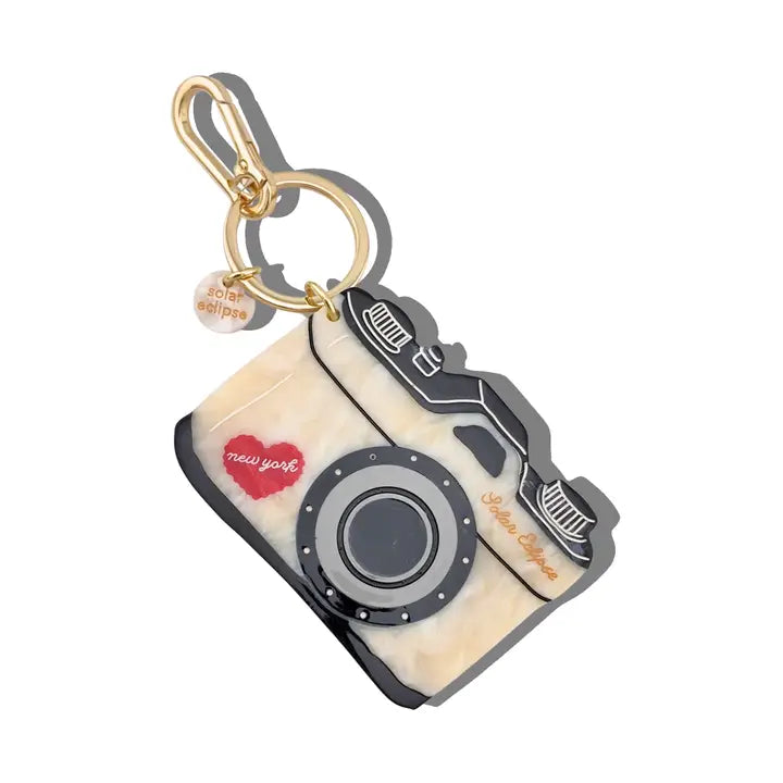 Camera-shaped keychain with 'New York' design on a white background