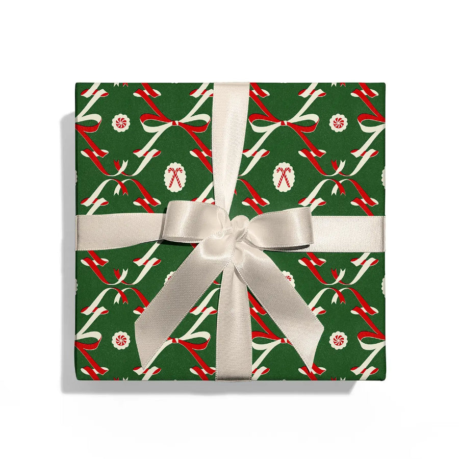 Gift box with festive design and white ribbon on a white background