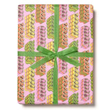 Wrapping paper with candy ribbons on a pink background