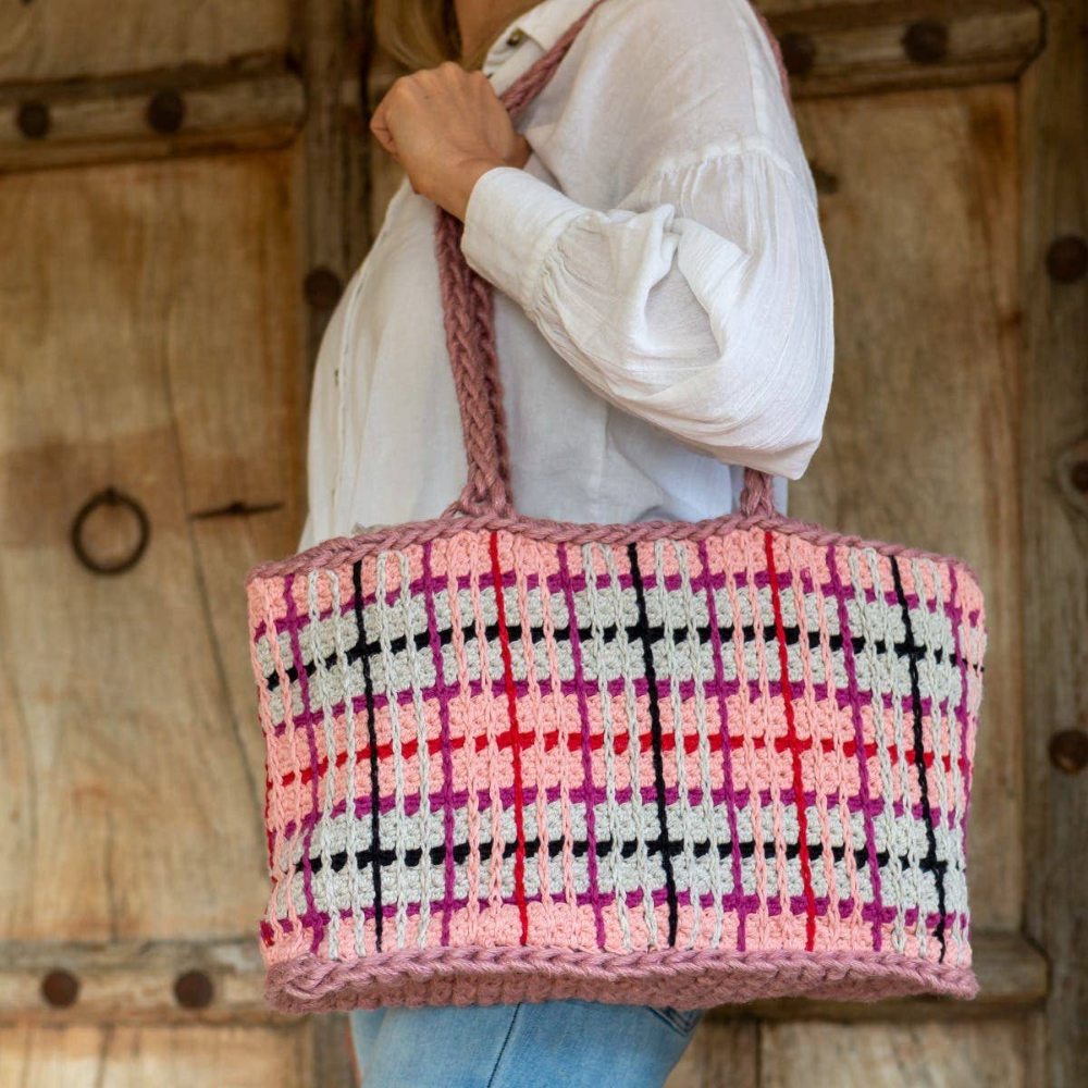 woman carrying multicolored checkered crochet bag