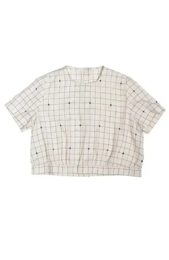 Short sleeve boxy top with a white and black grid printed fabric on a white background