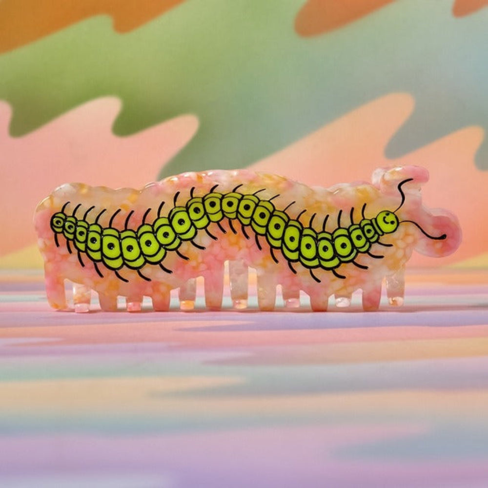 Hair clip with caterpillar design on a colorful background