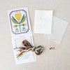 Kit includes beads, canvas, floss, needles, and color printed pattern on a white textured background