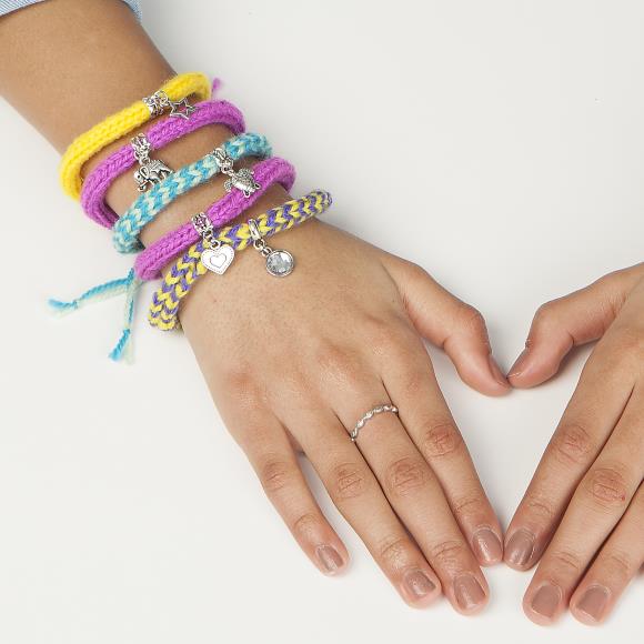 Hand showing off multiple charm bracelets on the wrist