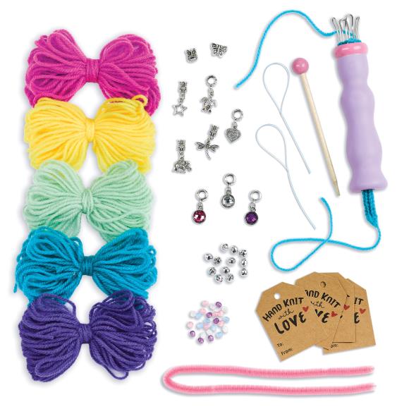 Contents of the kit, including various colors of yarn, charms, tags, chenille, beads, knitting tool, knitting pick and bead threader