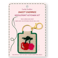 Lucky Feather Sweet Cherries needlepoint keychain kit on a pink card