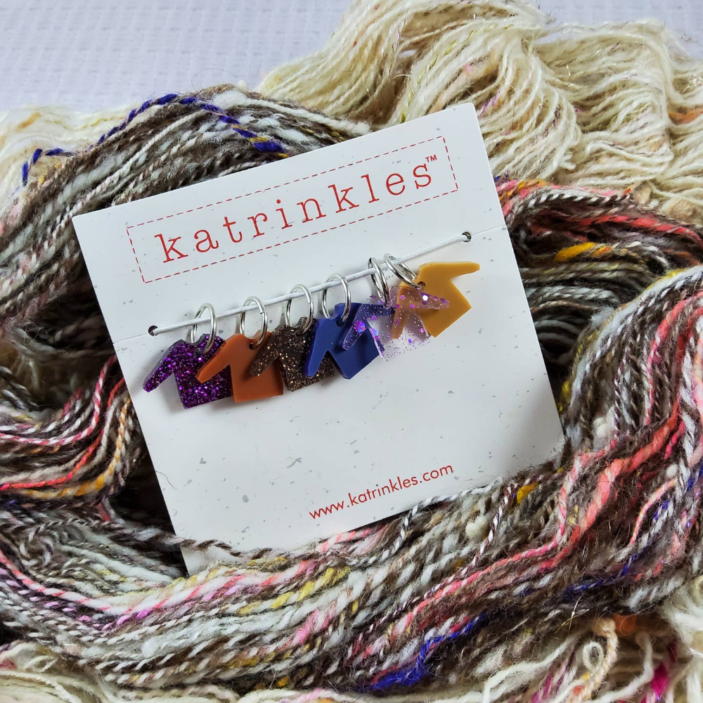 katrinkles packaging with 6 sweater-shaped sitch markers on a pile of yarn