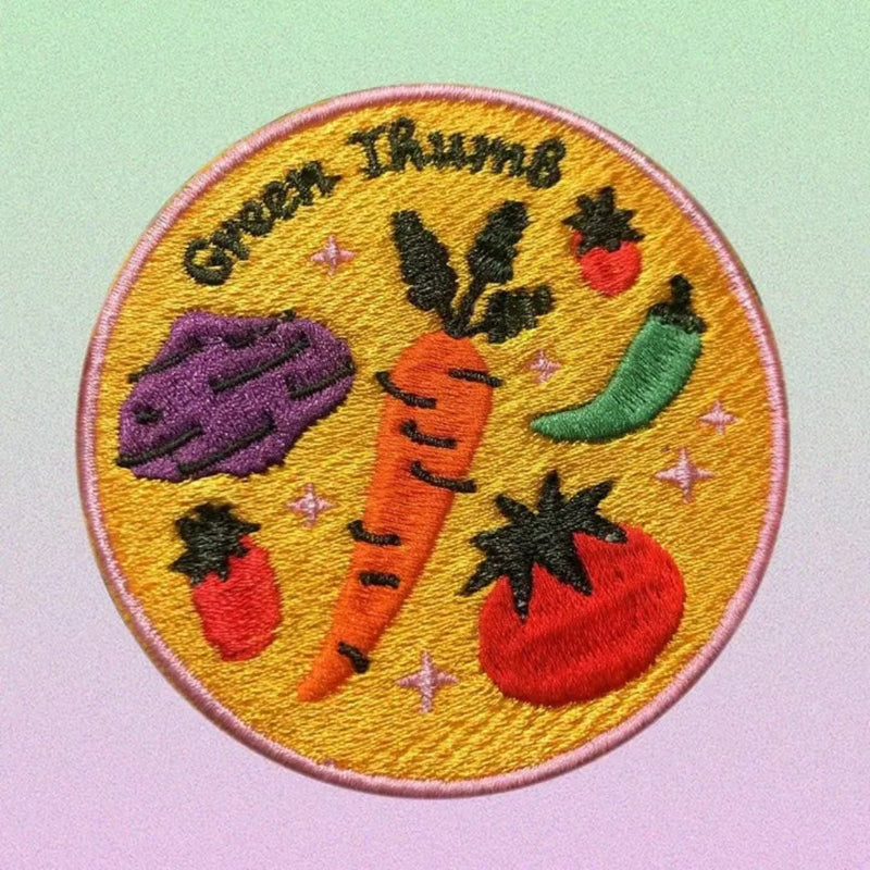Embroidered patch with vegetables and 'Green Thumb' text on a yellow background
