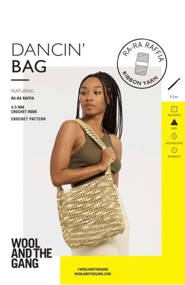 Model in a green tank top and white pants holding a crocheted tan and white shoulder bag on white and yellow  background with Wool and the Gang branding and text.