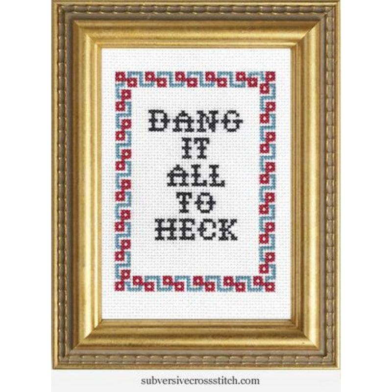 Cross-stitched phrase 'Dang it all to heck' in a decorative frame with geometric border.