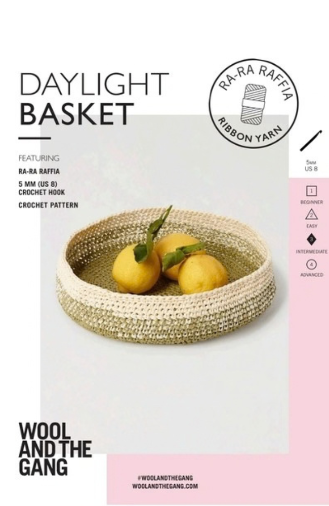 White and green crocheted basket with three lemons on a white and pink background with Wool and the Gang branding and text.