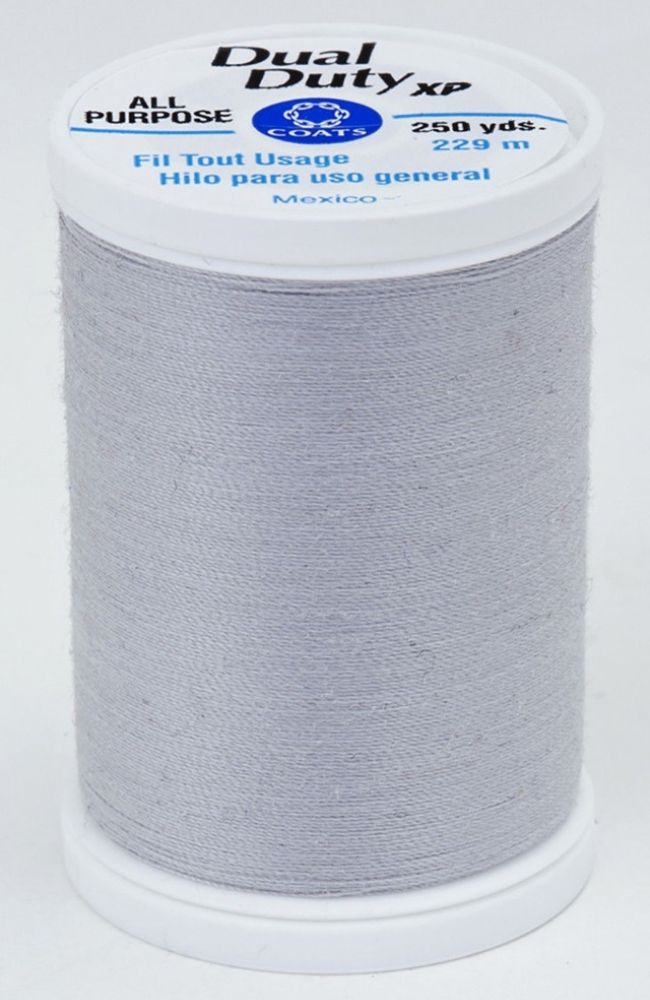 A spool of gray Dual Duty XP sewing thread with a white label featuring blue and black text, set against a plain white background.