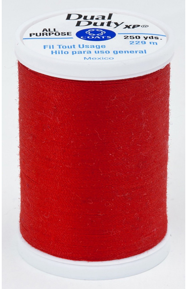 A spool of red Dual Duty XP sewing thread with a white label featuring blue and black text, set against a plain white background.