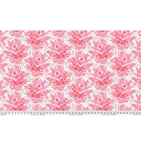 Patterned fabric with pink floral design with sharks in between on a white background with a ruler at the bottom.