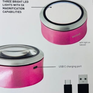 Pink magnifying glass with LED lights and USB charging port on a white background