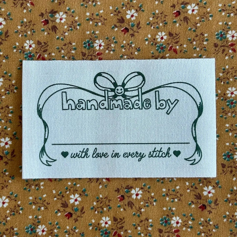 Label with 'handmade by' text on a floral fabric background