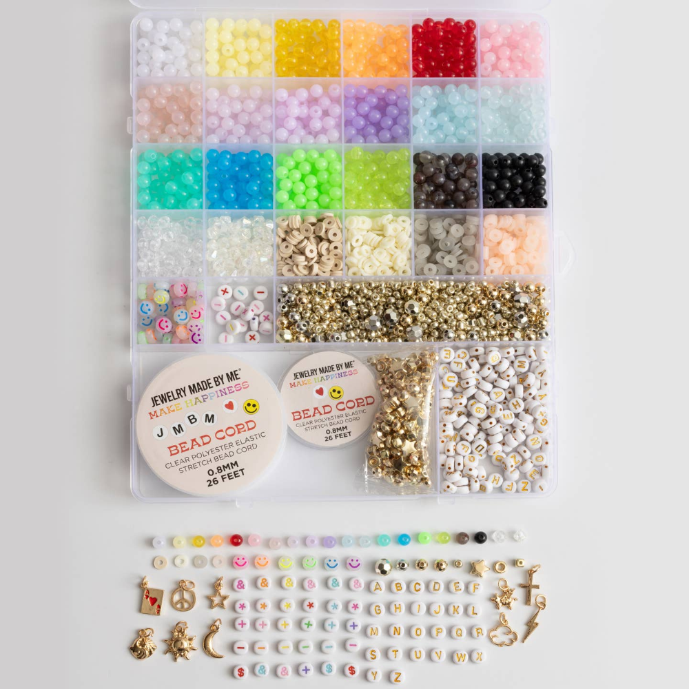 bead box with different compartments containing letter beads, metallic beads, and a variety of colorful beads and charms. Bead cord is included.