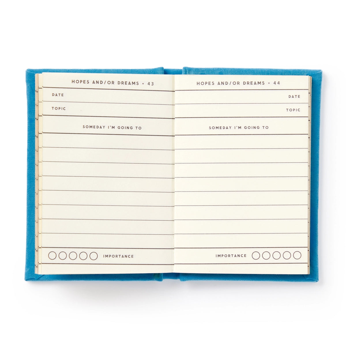 Open notebook with blue cover and lined pages on a white background