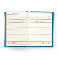 Open notebook with blue cover and lined pages on a white background