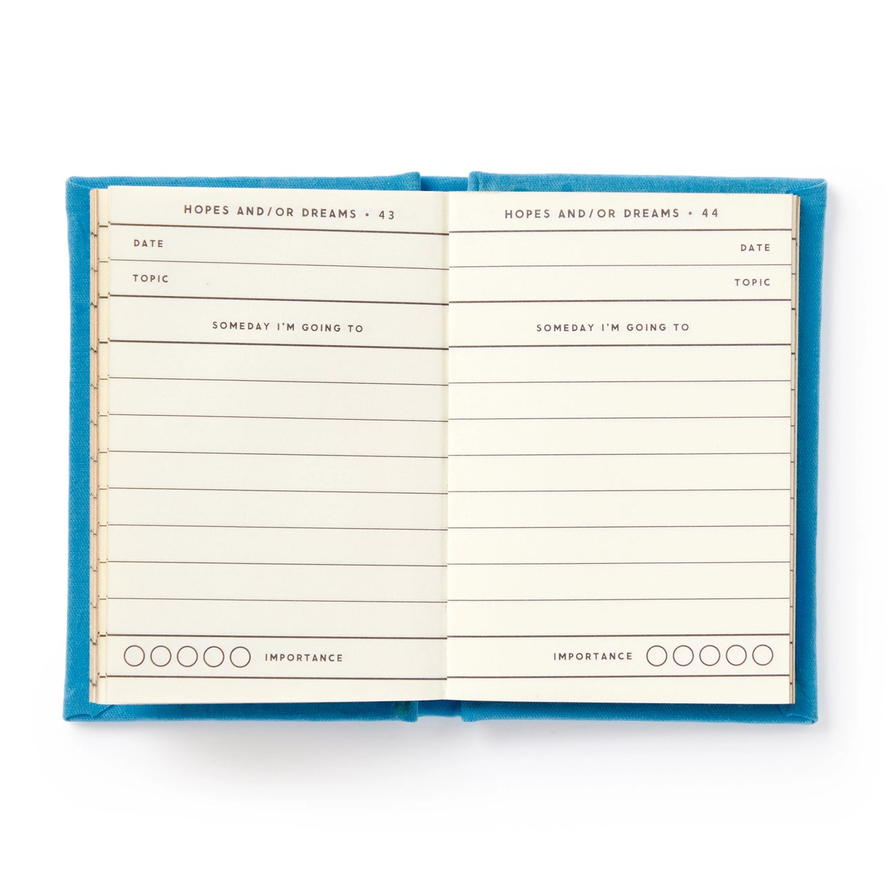 Open notebook with blue cover and lined pages on a white background