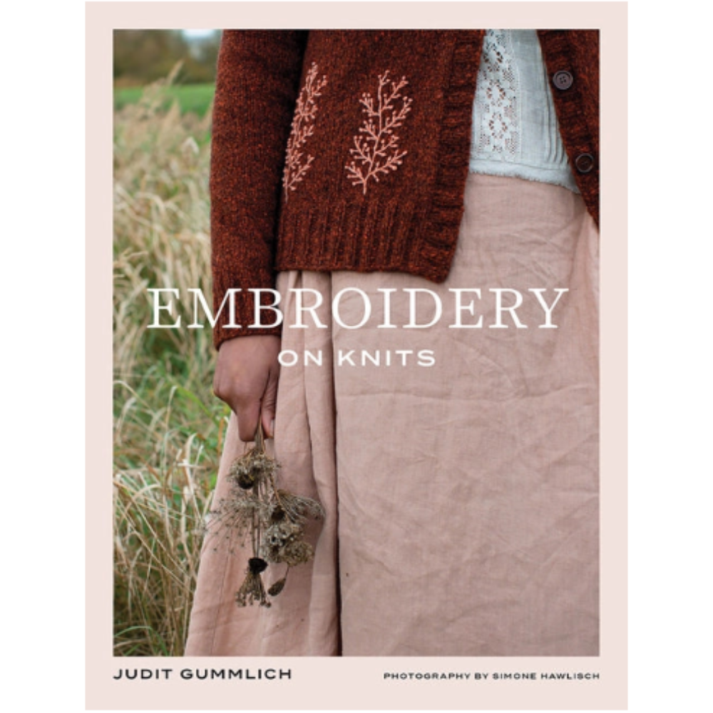 The cover of a book titled "Embroidery on Knits" by Judit Gummlich, with a photo of a person in a cardian with floral embroidery