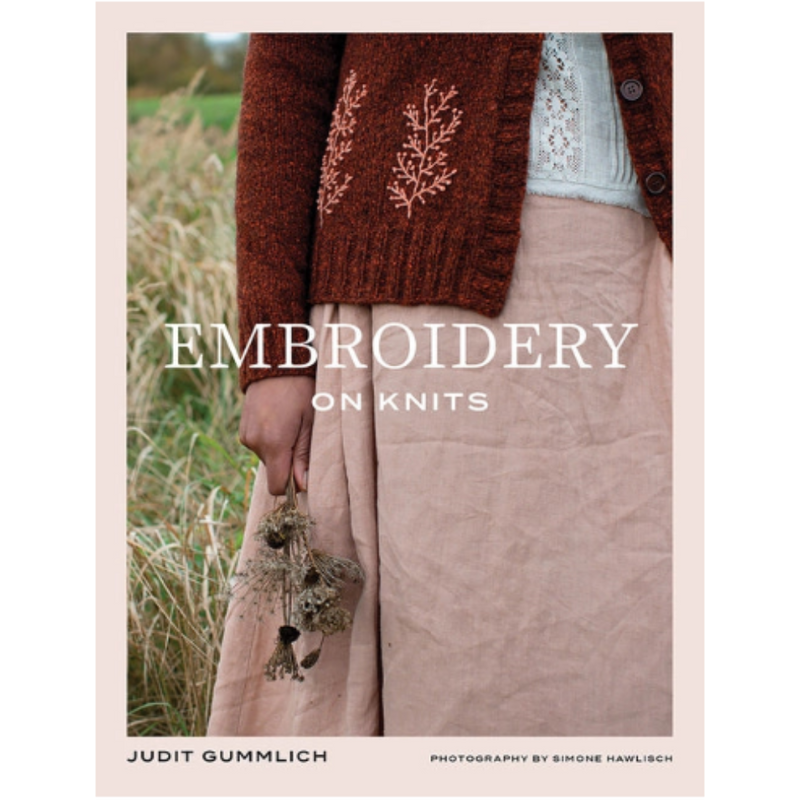 The cover of a book titled "Embroidery on Knits" by Judit Gummlich, with a photo of a person in a cardian with floral embroidery