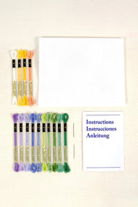 Set of embroidery threads and a manual on a light background