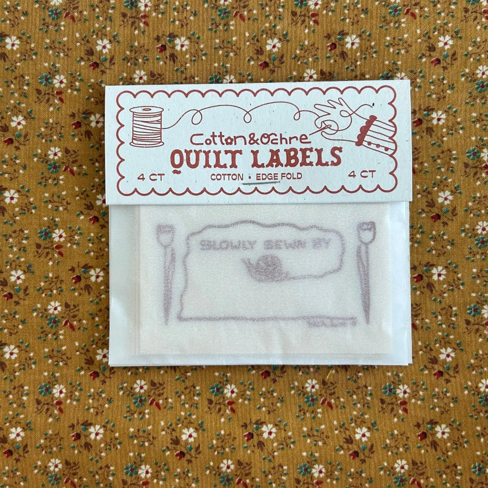 Cotton & Ochre quilt labels on a floral fabric background