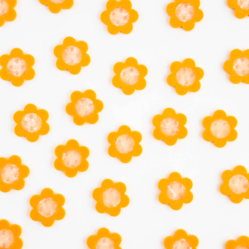 Pattern of yellow flowers with orange centers on a white background