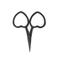 Black scissors with heart-shaped handles on a white background