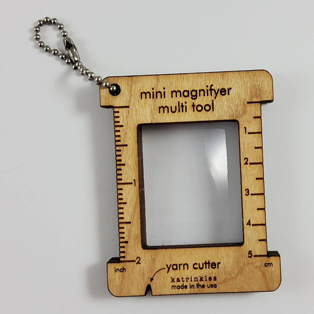 wooden framed magnifying glass with inch and centimeter measurement tools on the side