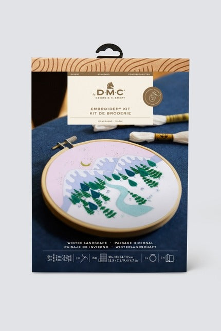 Embroidery kit packaging with a winter landscape design on a white background