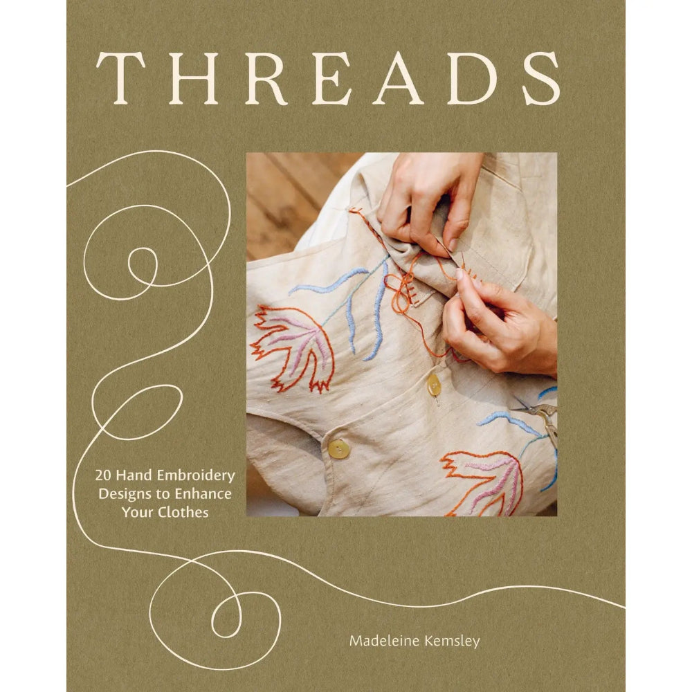 Book cover of 'Threads' with embroidery design and text on a beige background