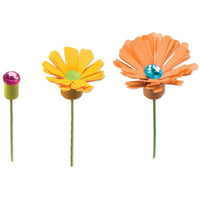 Three decorative flowers with colorful centers on a white background
