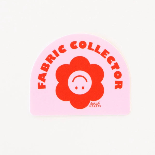 'Fabric Collector' sticker with  red flower design on a pink background