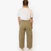 Person wearing a white t-shirt and olive green pants on a white background