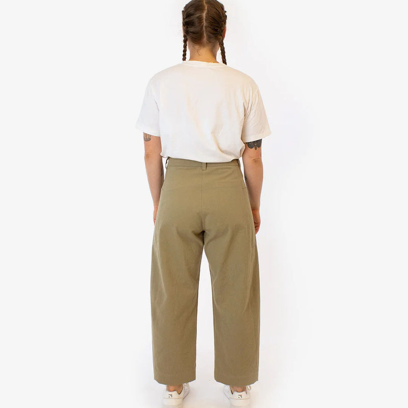 Person wearing a white t-shirt and olive green pants on a white background