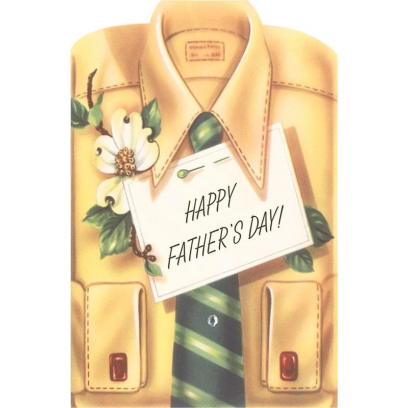 Folded yellow shirt with green tie, white flower, and sign reading 'Happy Father's Day!'