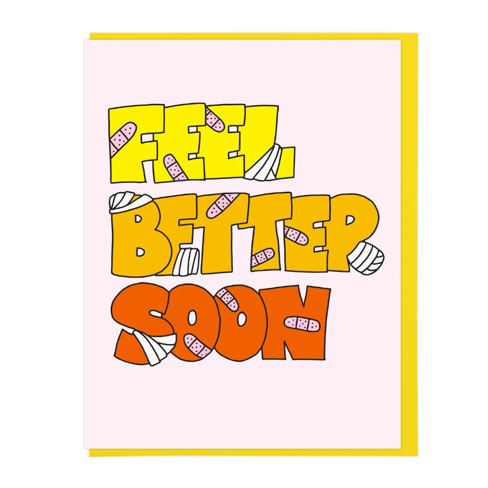 A greeting card with a light pink background featuring the words 'FEEL BETTER SOON' in large yellow, orange, and red letters decorated with illustrations of band-aids.