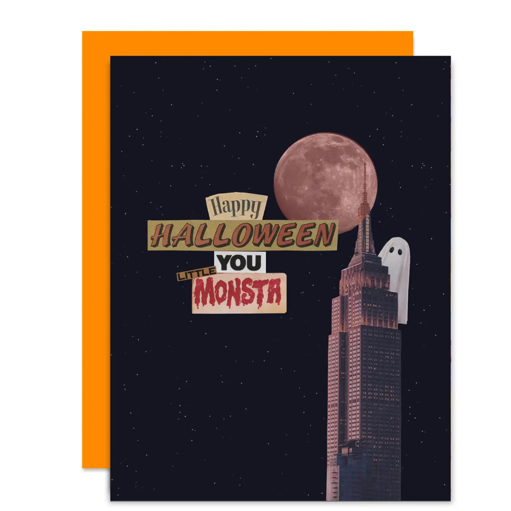 A Halloween greeting card featuring a dark night sky, a large moon, a stylized skyscraper, a ghost, and the text 'Happy HALLOWEEN YOU LITTLE MONSTA,' shown with an orange envelope behind it.