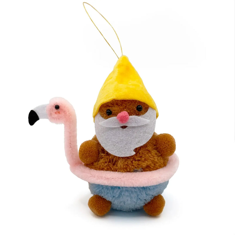 Gnome wearing a yellow hat in a flamingo floaty tube pom pom ornament on a white background.