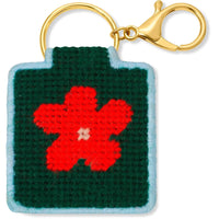 Needlepoint keychain with red flower design on green background