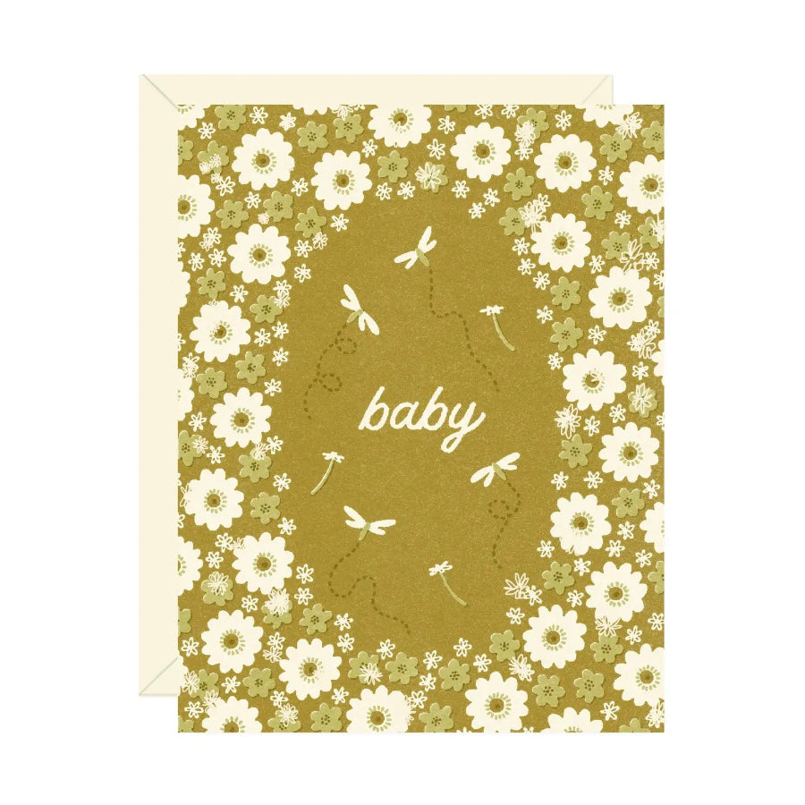 Green card with white flowers and dragonflies with the word "baby" in the center