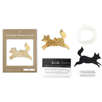 Stitched ornament kit with gold and black fox designs on a white background