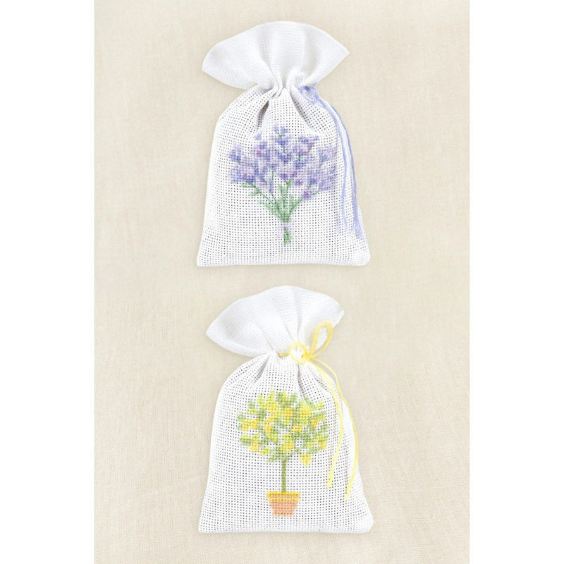 Two drawstring bags with floral designs on a beige background