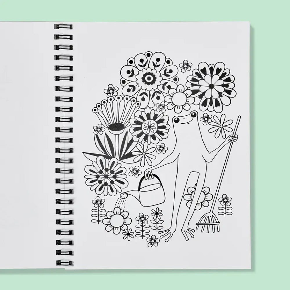 Spiral-bound coloring book with a black and white illustration of a gardener froggy surrounded by flowers on a light green background.
