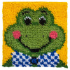 Completed latch hook square project, featuring a cartoon froggy design on a yellow background. The froggy has rosy cheeks and is wearing a blue and white checkered vest.