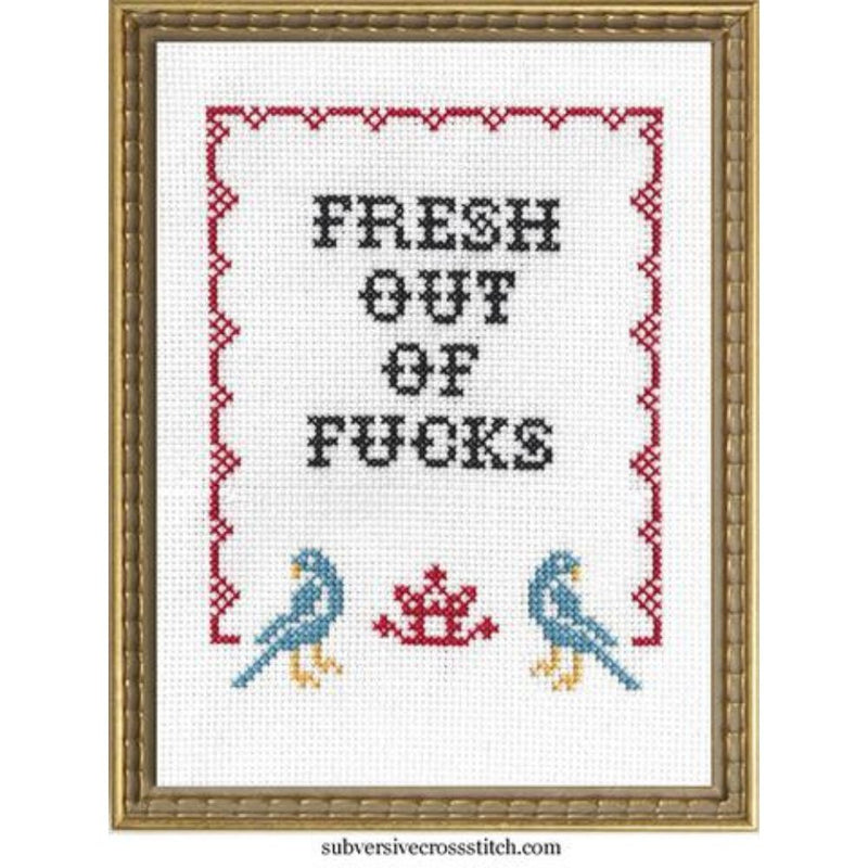 Cross-stitched design with text and birds in a decorative frame.