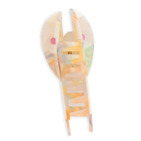 A translucent claw hair clip with a translucent body, set against a plain white background.